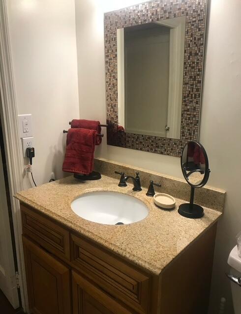 bathroom featuring vanity and toilet