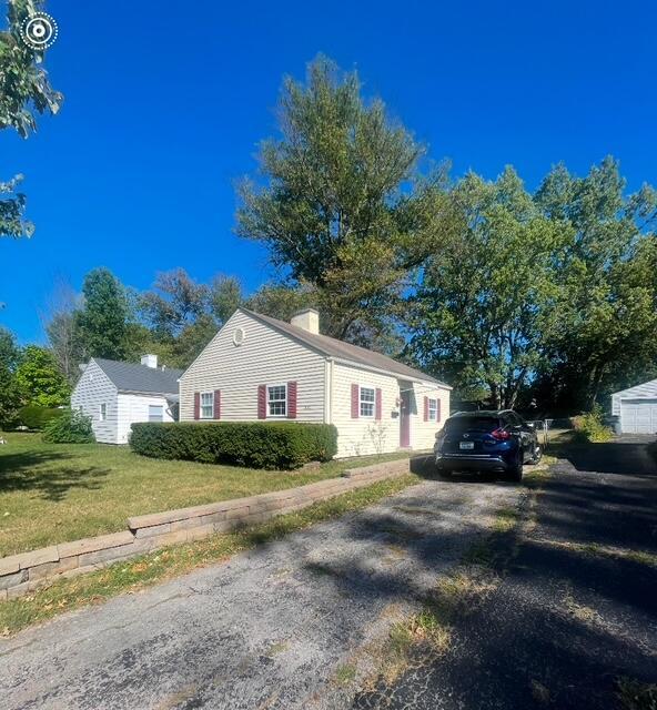 view of side of home with a lawn