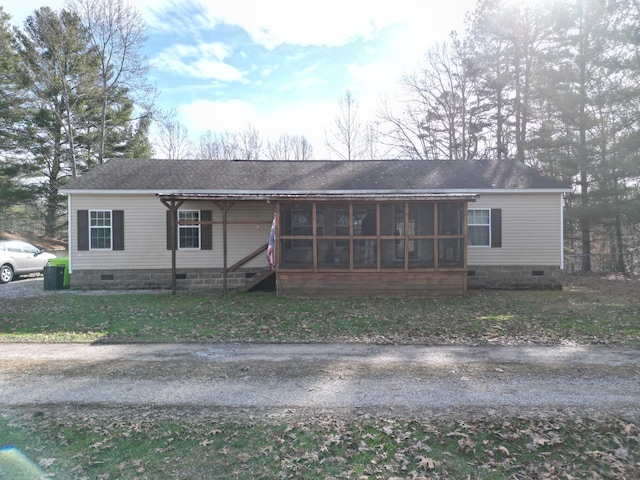 view of front of house with a sunroom and a front yard