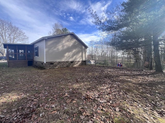 view of side of property featuring a sunroom