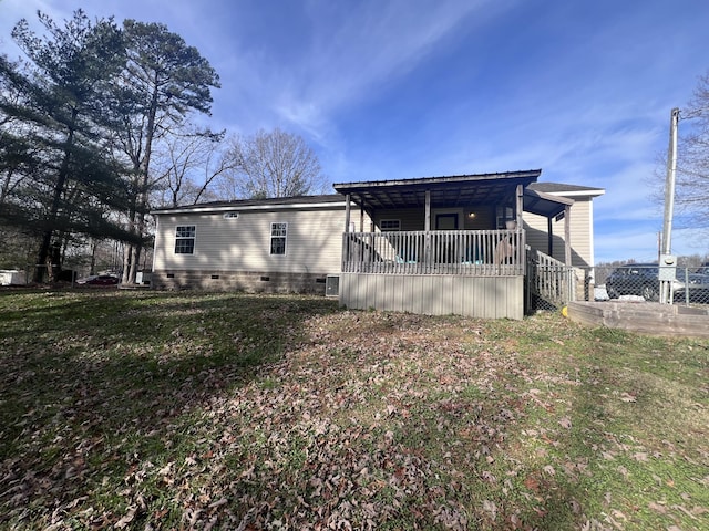 rear view of house with a lawn