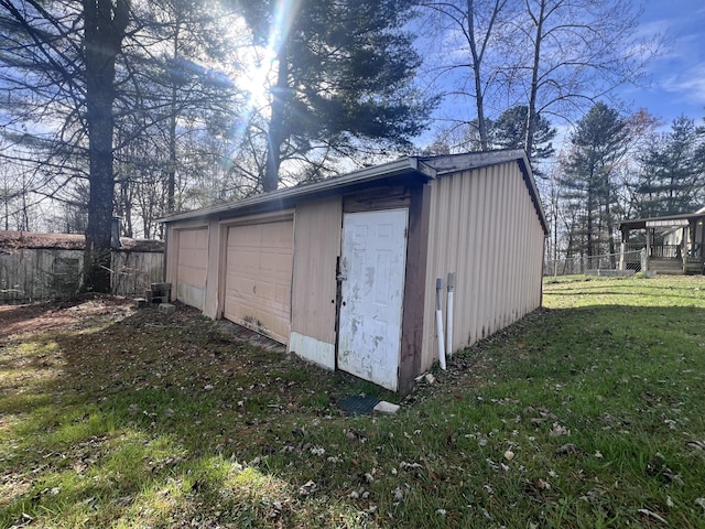 view of outbuilding with a lawn and a garage