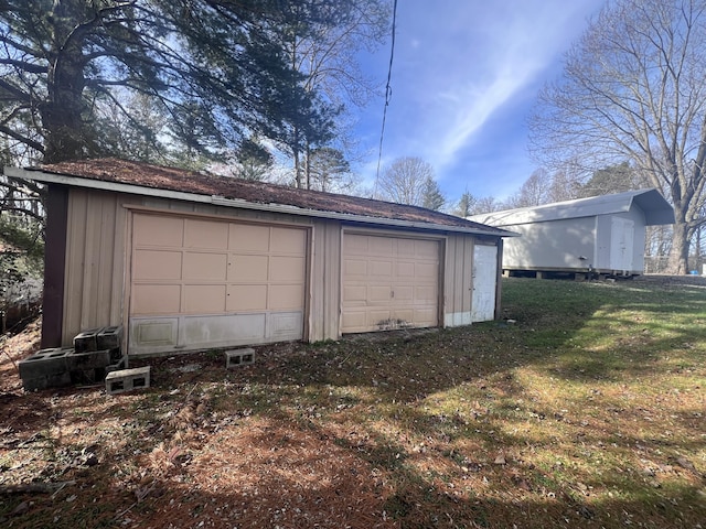 garage featuring a yard