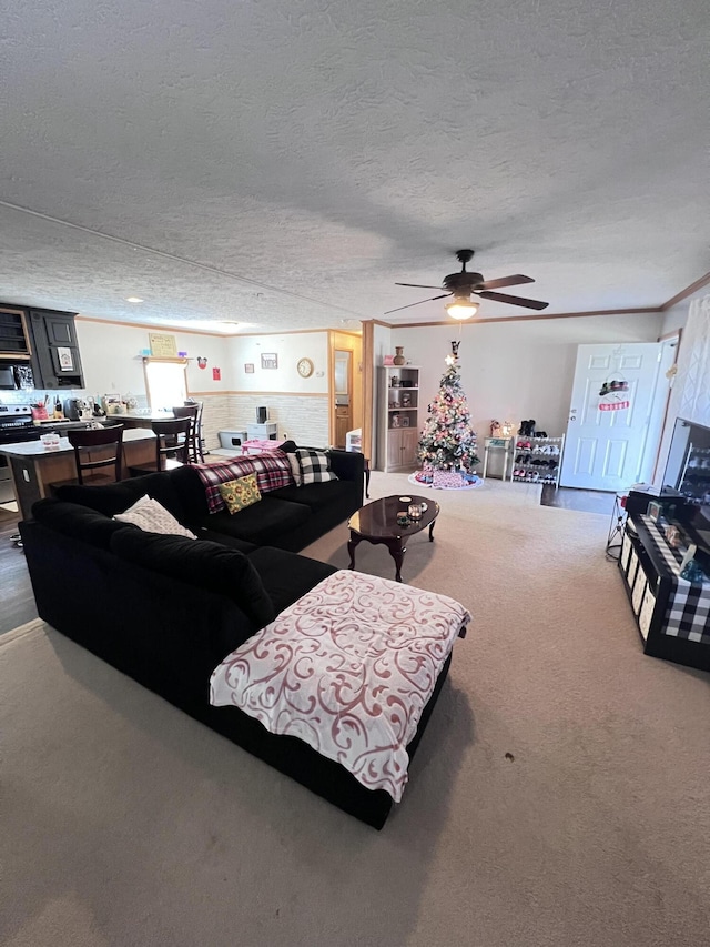 living room with carpet, a textured ceiling, and ceiling fan