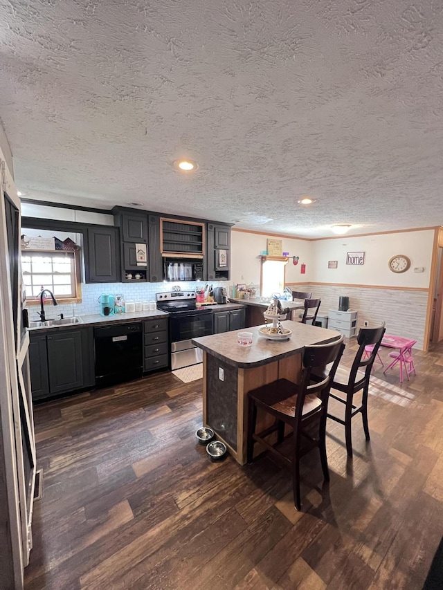 kitchen featuring dark wood-type flooring, electric stove, sink, a textured ceiling, and black dishwasher