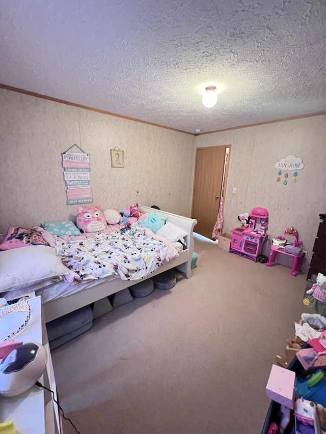 bedroom with a textured ceiling and carpet floors