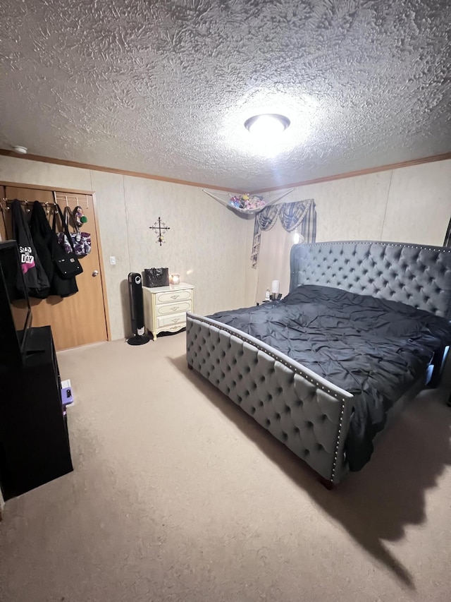 carpeted bedroom with crown molding and a textured ceiling