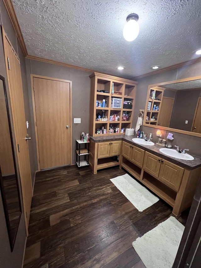 interior space with dark hardwood / wood-style flooring, a textured ceiling, and sink