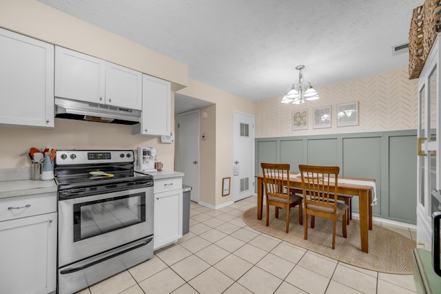 kitchen featuring white cabinets, hanging light fixtures, stainless steel electric range, and a notable chandelier