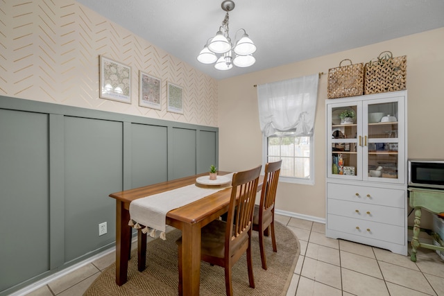 tiled dining space featuring an inviting chandelier