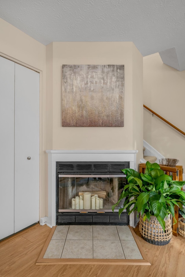 room details featuring a textured ceiling and hardwood / wood-style flooring