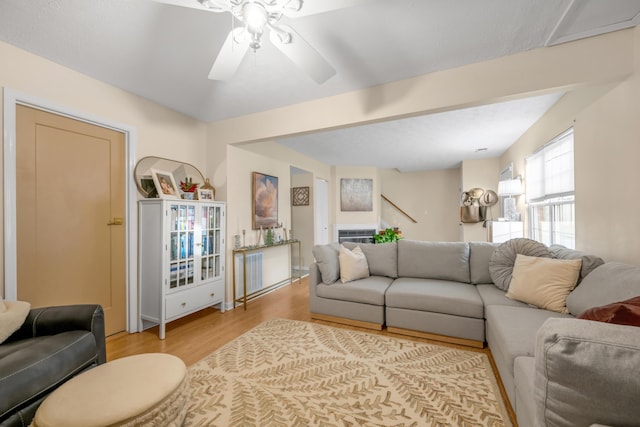 living room with ceiling fan and light hardwood / wood-style floors