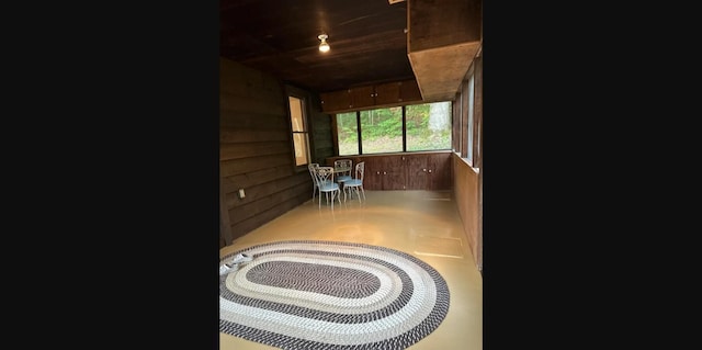 interior space featuring wooden walls and wooden ceiling