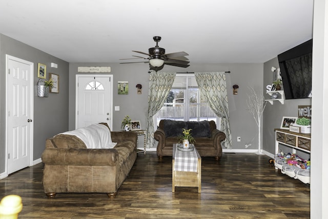 living room featuring ceiling fan and dark hardwood / wood-style floors