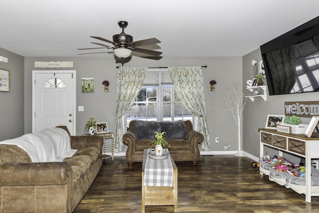 living room featuring ceiling fan and dark wood-type flooring