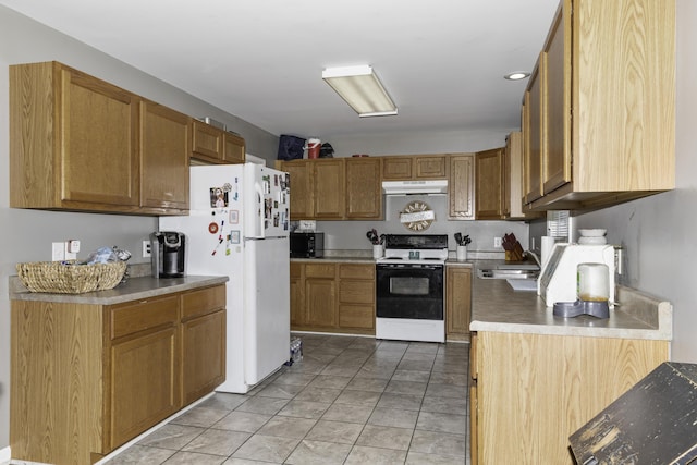 kitchen with light tile patterned floors, white appliances, and sink