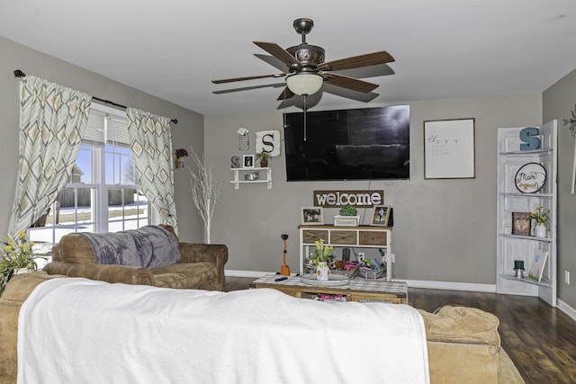 living room with ceiling fan and dark hardwood / wood-style flooring