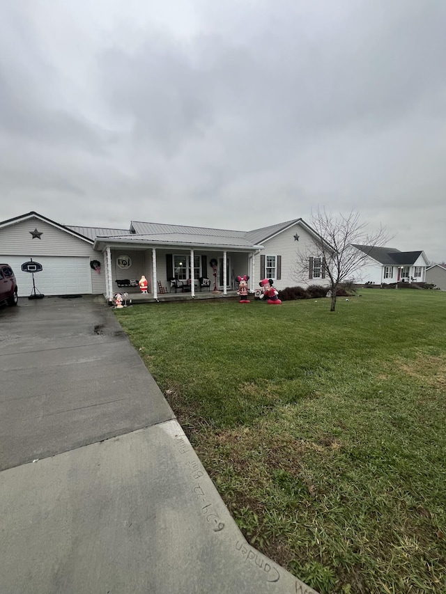 ranch-style home featuring a porch, a garage, and a front lawn