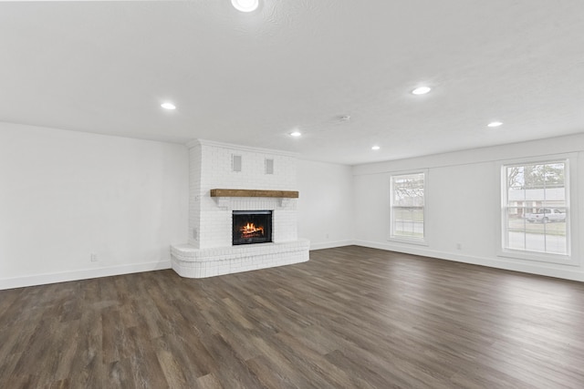 unfurnished living room with a fireplace and dark hardwood / wood-style flooring