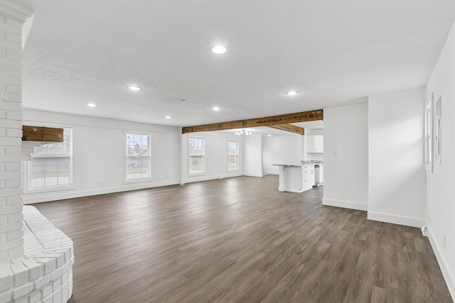 unfurnished living room with a fireplace and dark wood-type flooring