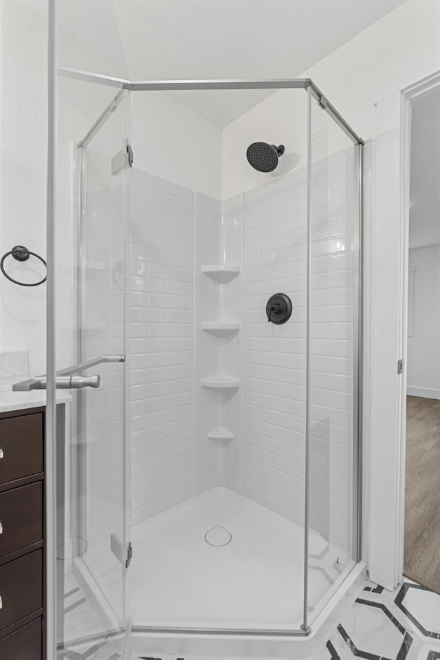 bathroom featuring wood-type flooring and a shower with door