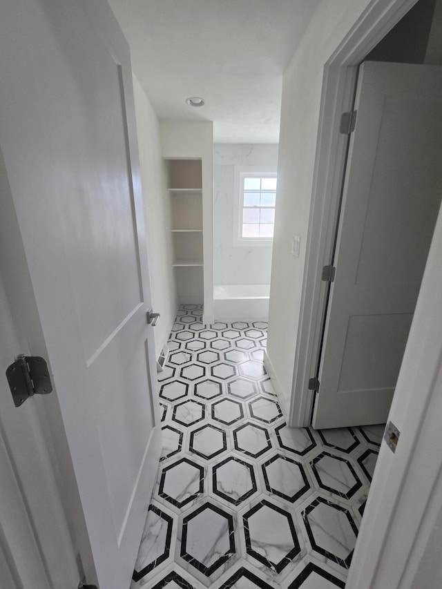 bathroom featuring tile patterned floors and a washtub