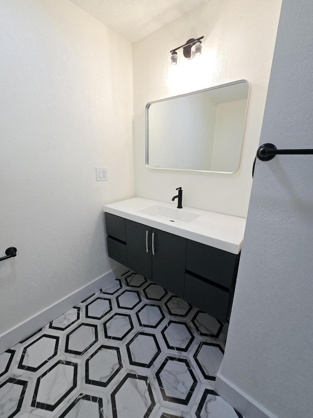 bathroom featuring tile patterned flooring and vanity