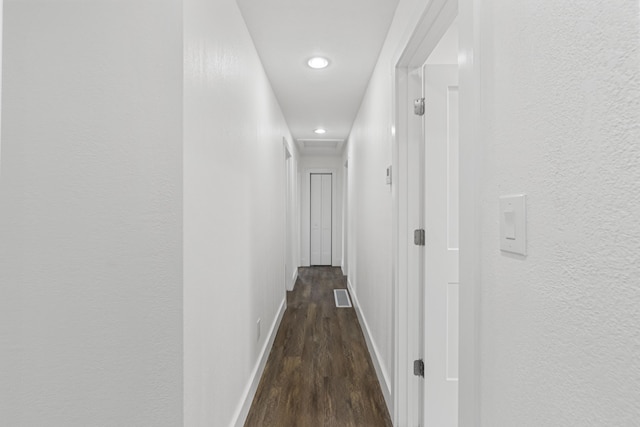 hall with dark hardwood / wood-style flooring