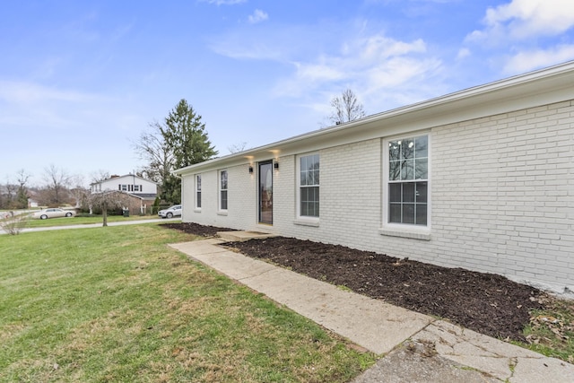 view of home's exterior with a lawn