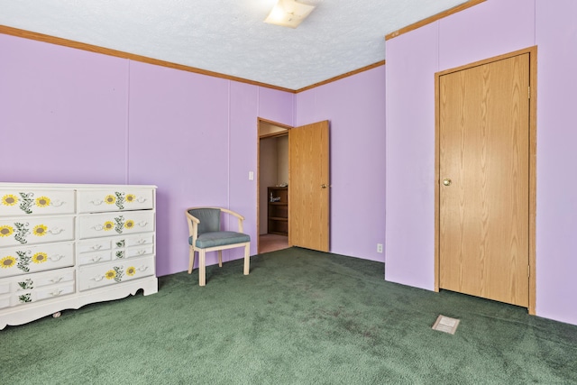 bedroom with ornamental molding, a textured ceiling, and dark colored carpet