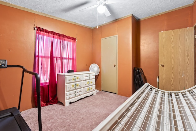 bedroom featuring a textured ceiling, light colored carpet, and ceiling fan