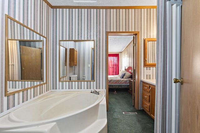 bathroom with a washtub, a textured ceiling, and toilet