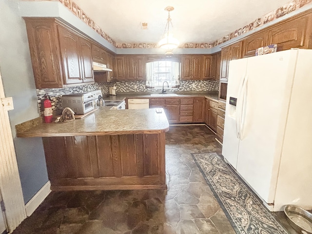 kitchen with white appliances, backsplash, sink, decorative light fixtures, and kitchen peninsula