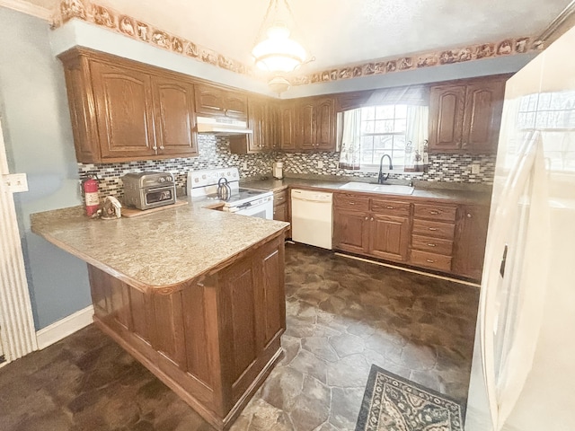 kitchen with kitchen peninsula, decorative backsplash, white appliances, sink, and hanging light fixtures