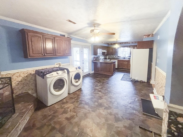 laundry area featuring french doors, sink, washer and dryer, ceiling fan, and ornamental molding