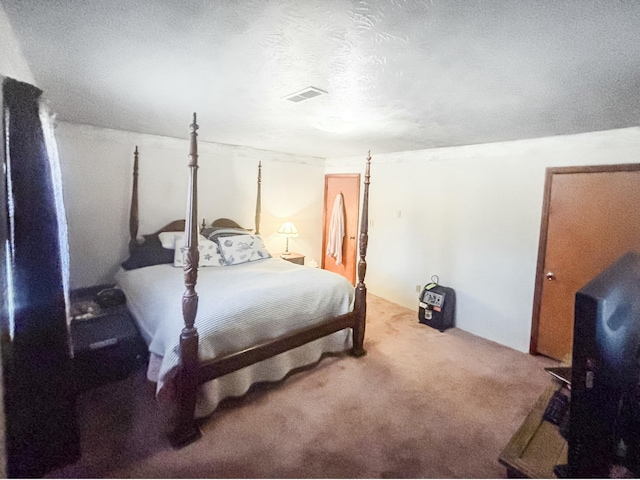 bedroom featuring carpet flooring and a textured ceiling