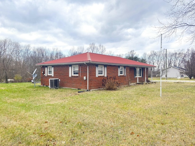 view of property exterior featuring a lawn and central AC