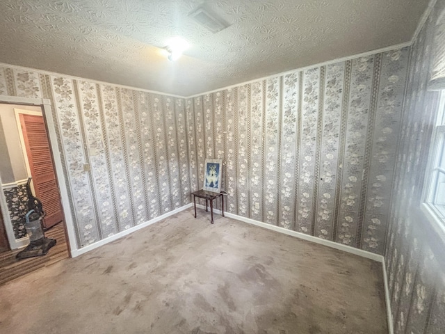 carpeted empty room with a textured ceiling