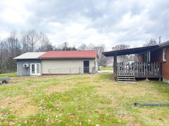 exterior space with a deck, a wall mounted AC, and french doors