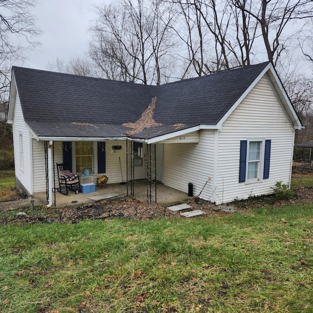 view of front of house with a front yard and a patio