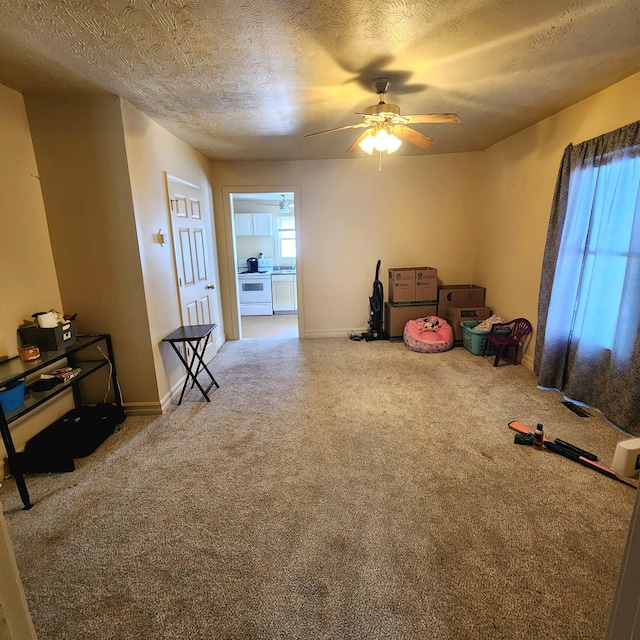 misc room with a textured ceiling and ceiling fan