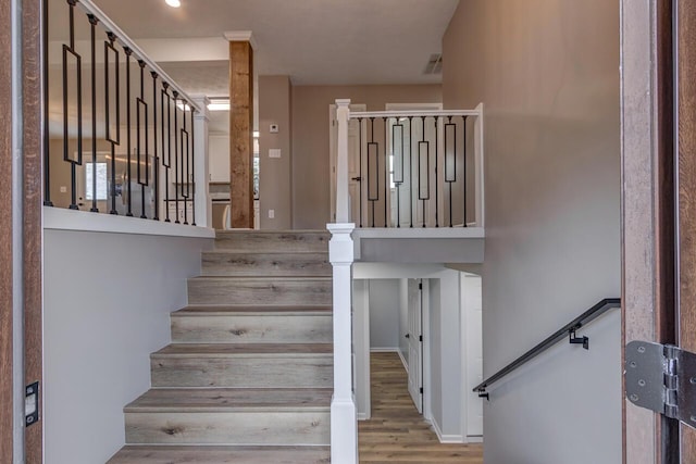 stairway with hardwood / wood-style floors