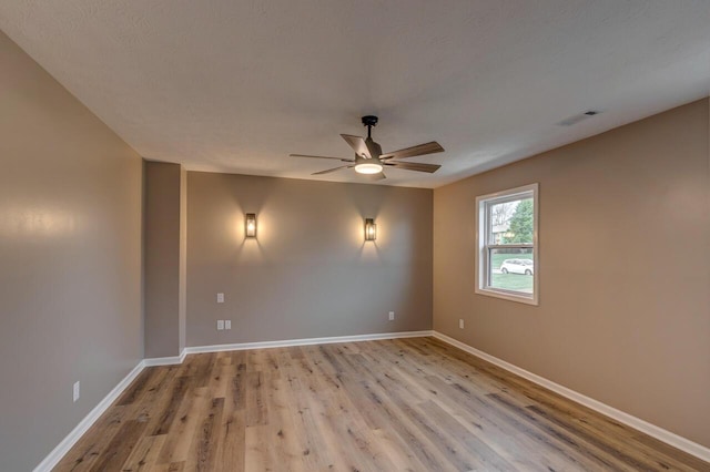 spare room featuring ceiling fan and light hardwood / wood-style floors