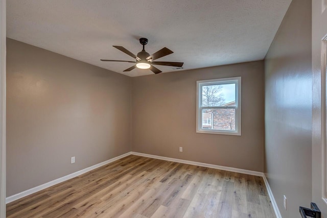 spare room featuring ceiling fan, a textured ceiling, and light hardwood / wood-style flooring