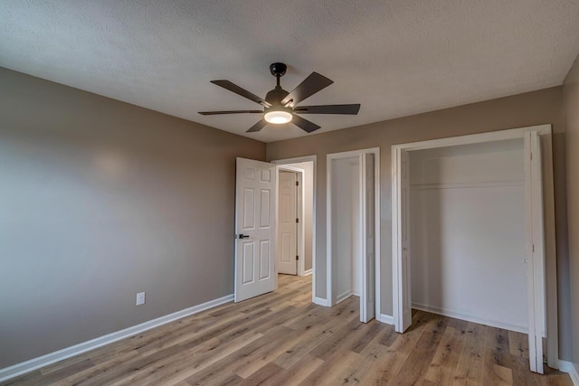 unfurnished bedroom with ceiling fan, a textured ceiling, and light hardwood / wood-style flooring