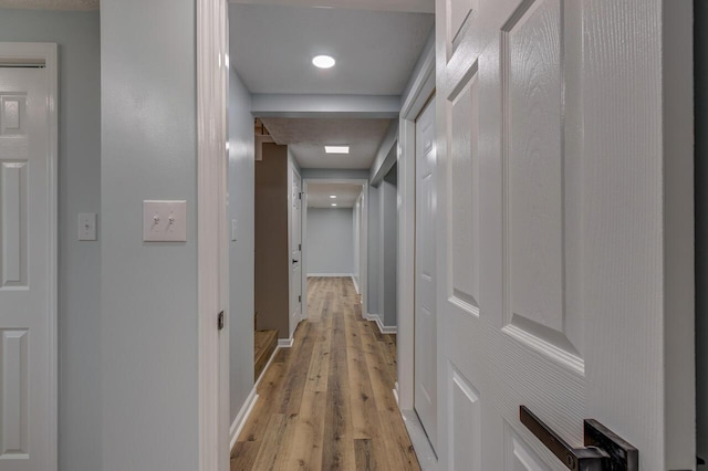 corridor with light hardwood / wood-style flooring