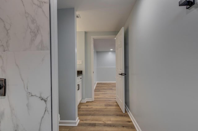 corridor with light hardwood / wood-style flooring