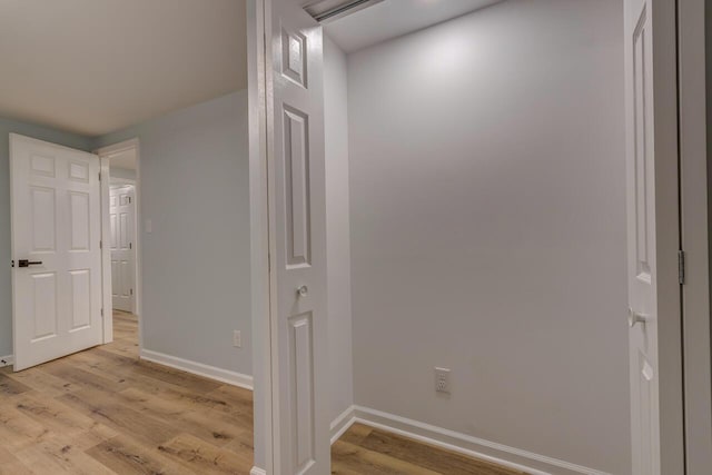 corridor with light hardwood / wood-style flooring