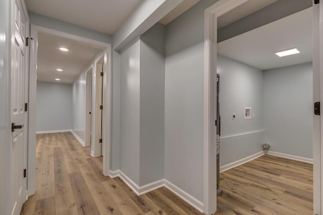 hallway with light hardwood / wood-style flooring