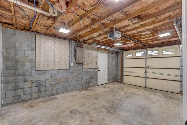 garage with electric panel and a garage door opener